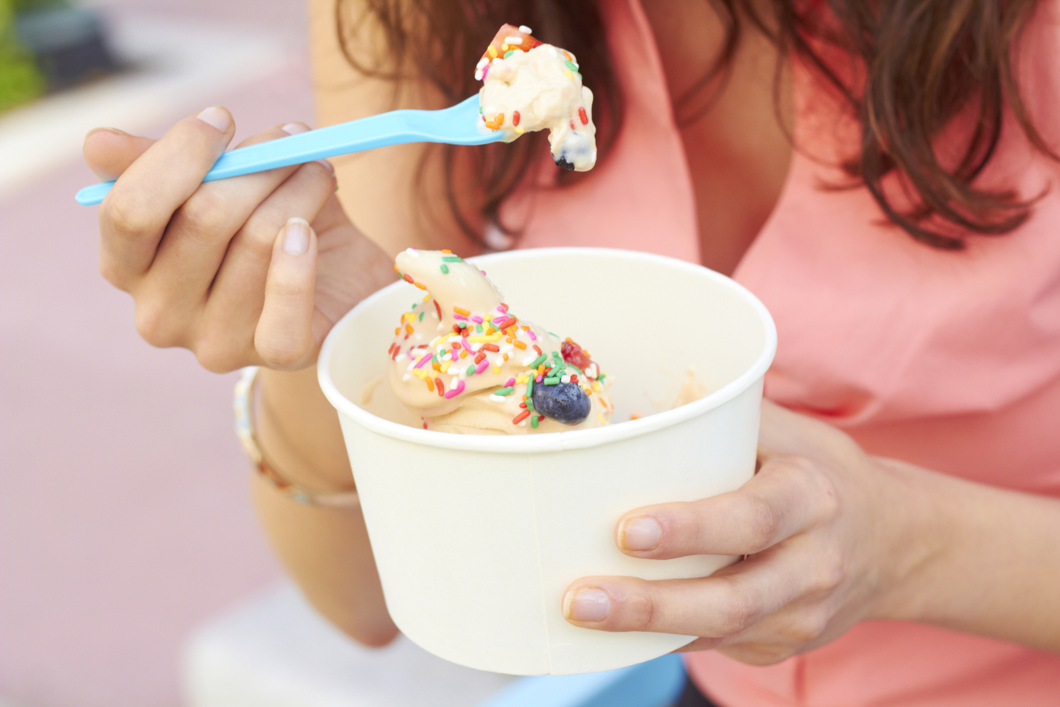 Woman Eating Frozen Yogurt With Berries Woman Eating Frozen Yogurt With Berries