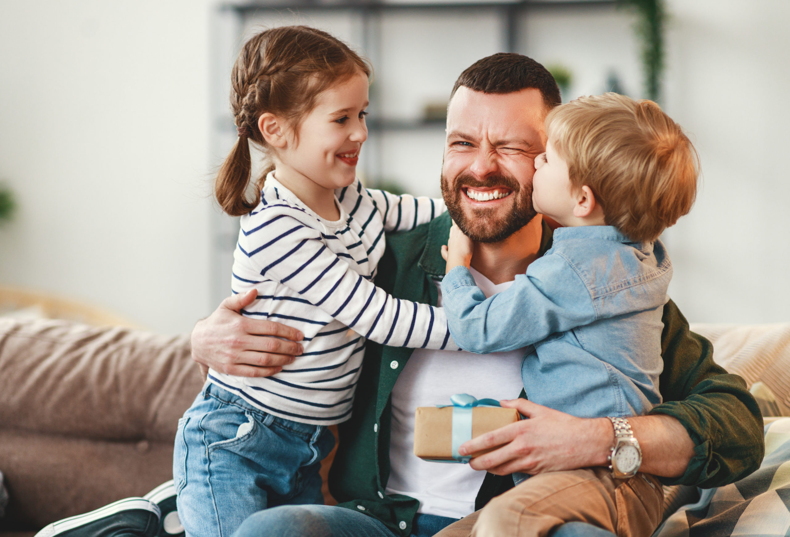 Happy father getting congratulations from kids Happy father getting congratulations from kids
