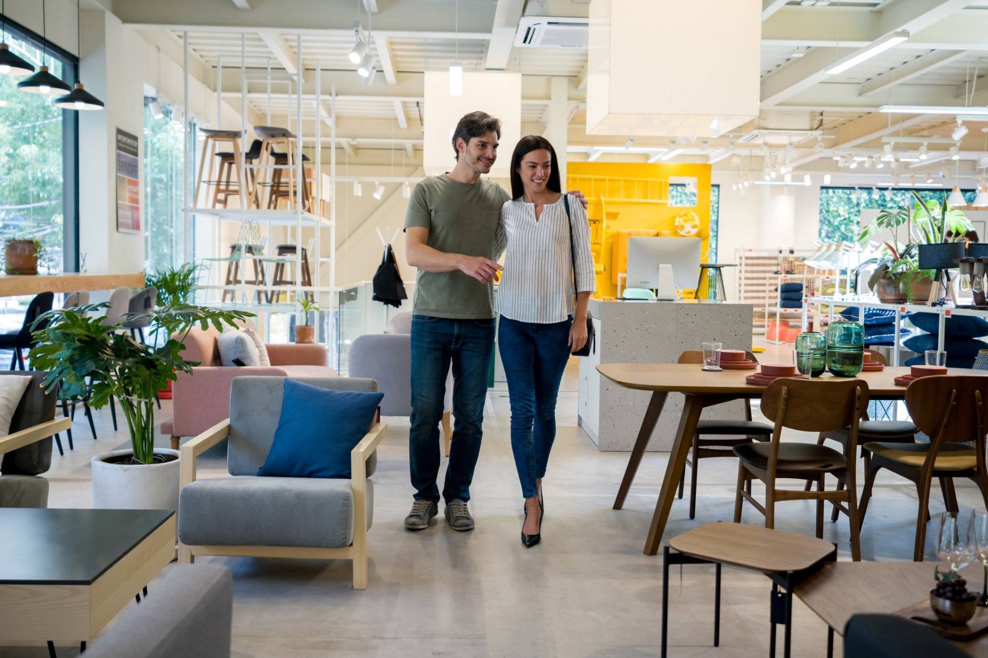 Happy couple selecting items for the wedding registry at a furniture store Happy couple selecting items for the wedding registry at a furniture store