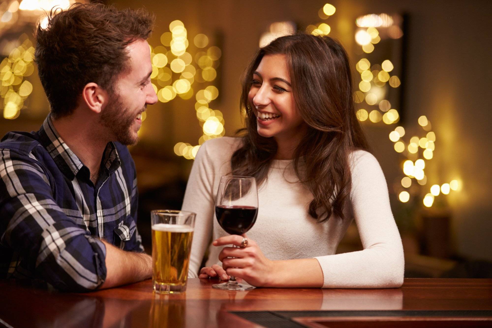 Couple Enjoying Evening Drinks In Bar Couple Enjoying Evening Drinks In Bar