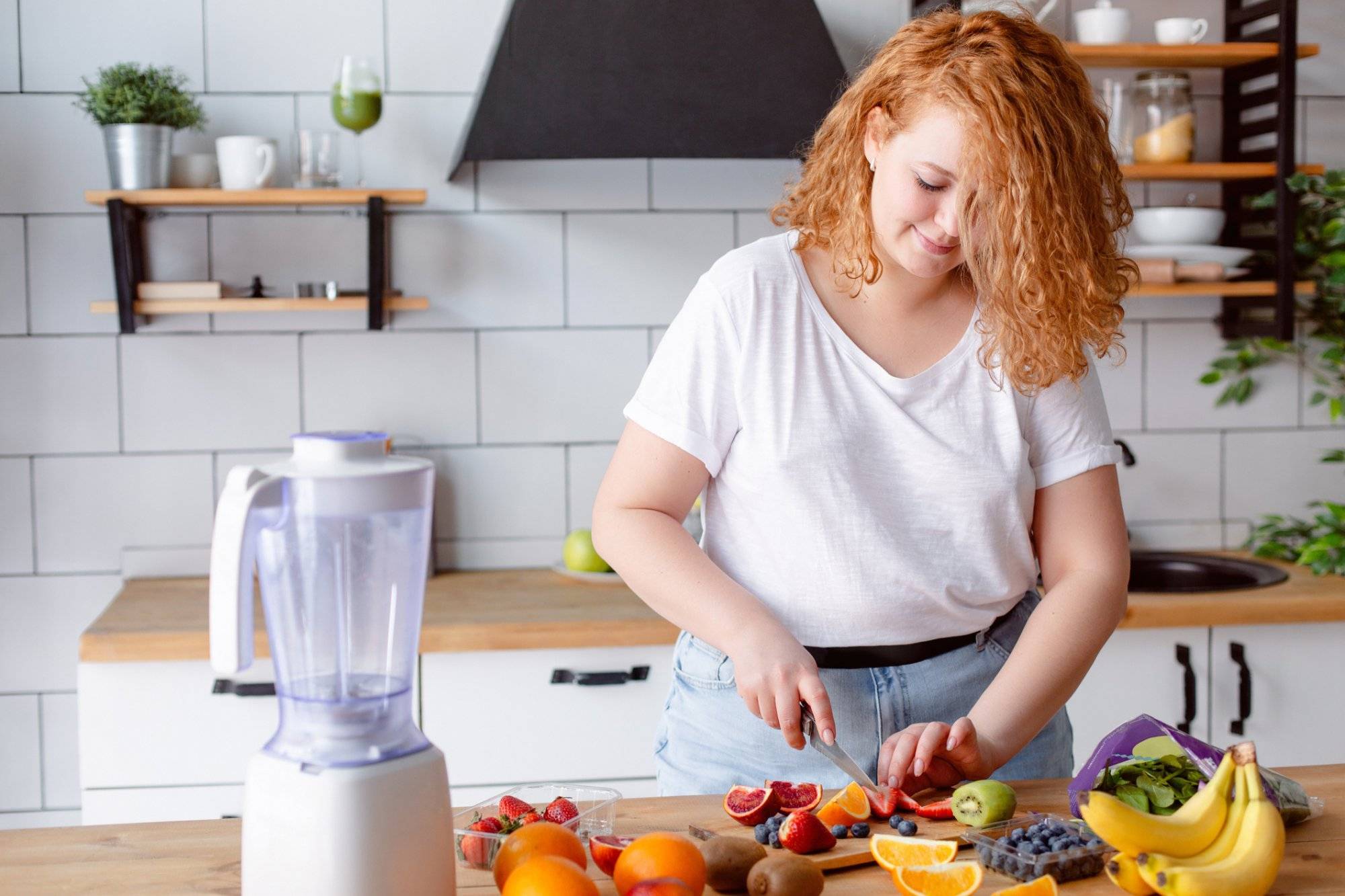 Portrait of a beautiful smiling woman preparing smoothie at home kitchen. Portrait of a beautiful smiling woman preparing smoothie at home kitchen.