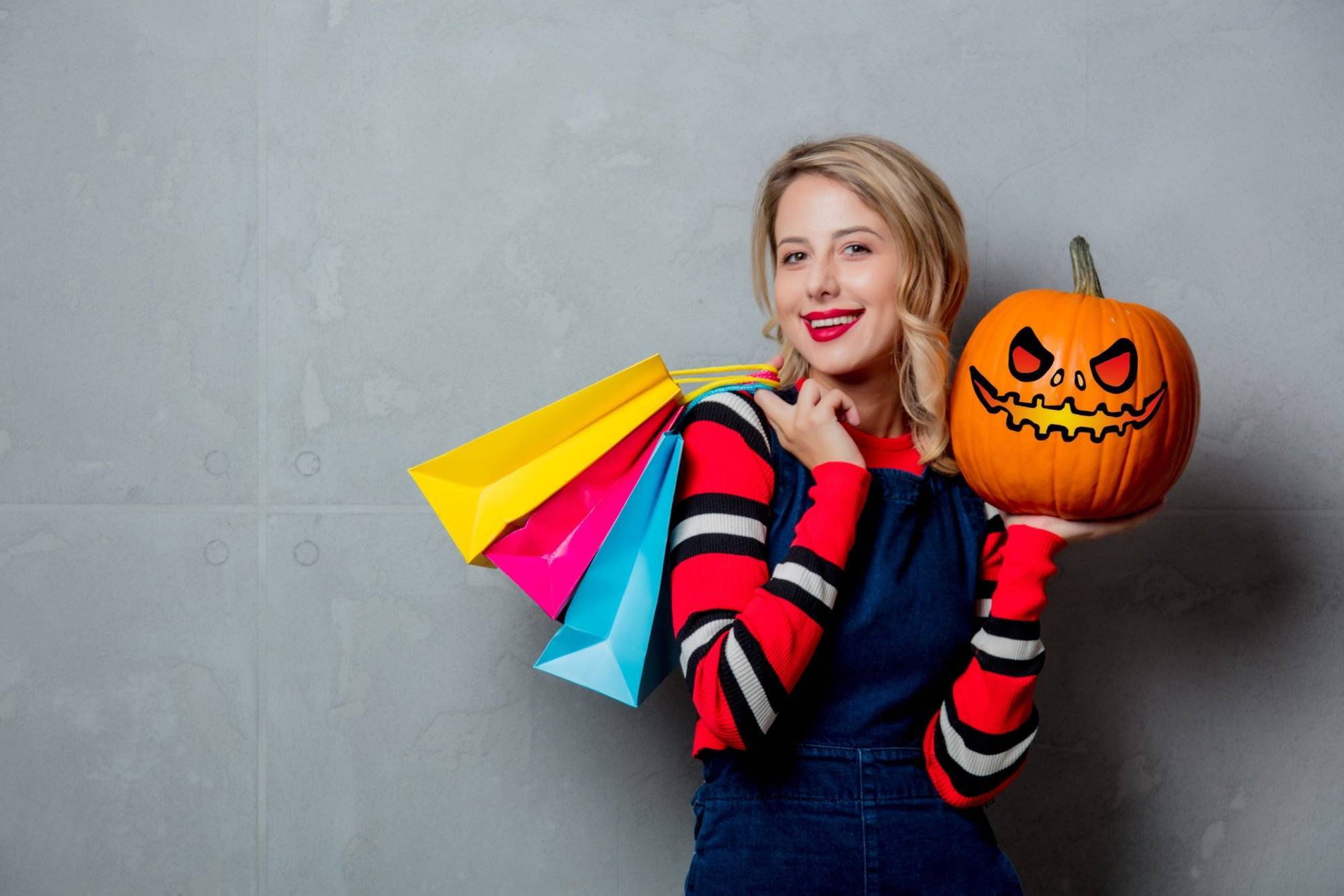 girl with shopping bags and halloween pumpkin girl with shopping bags and halloween pumpkin