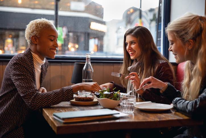 Londoners women eating together at a restaurant Londoners women eating together at a restaurant