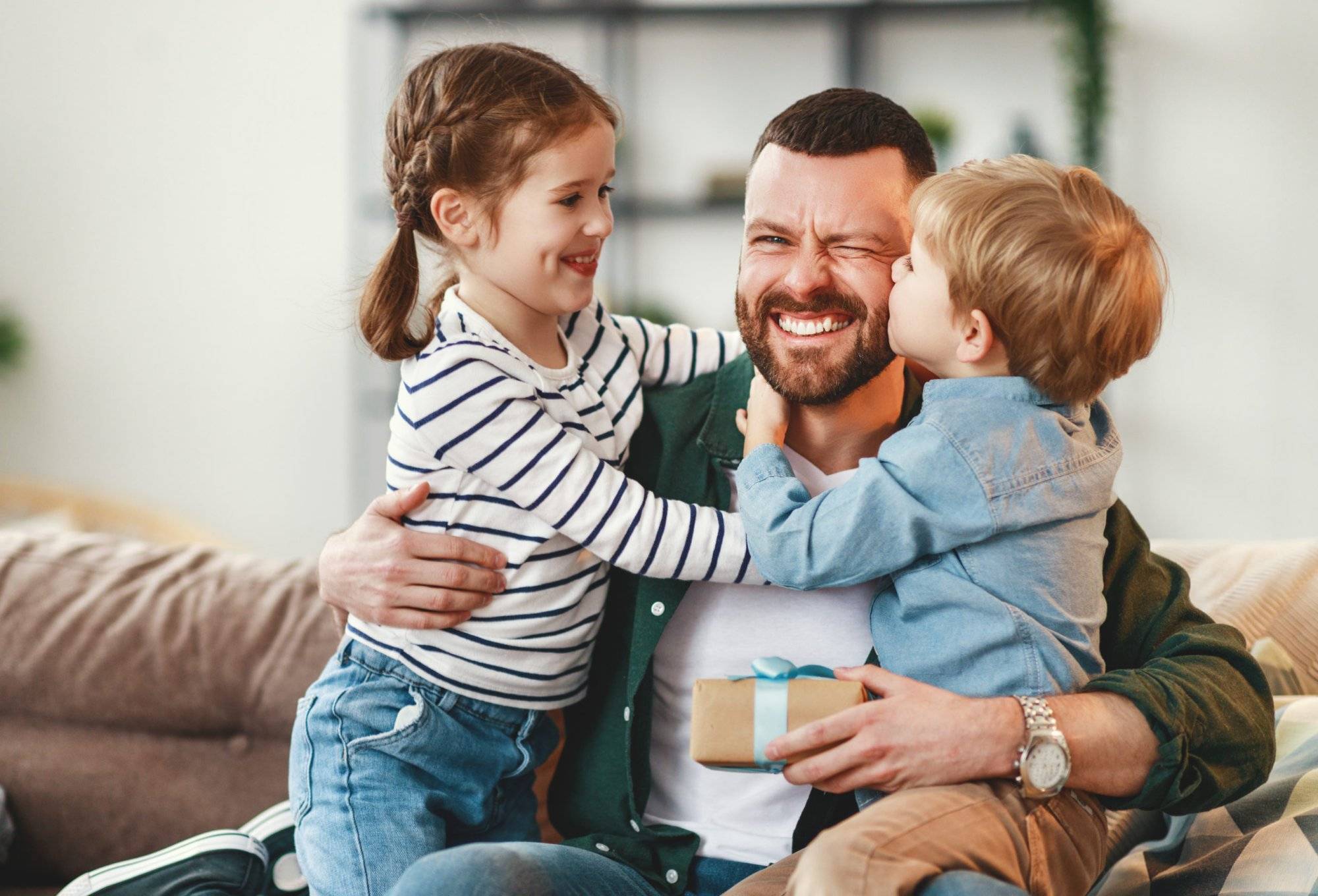 Happy father getting congratulations from kids Happy father getting congratulations from kids