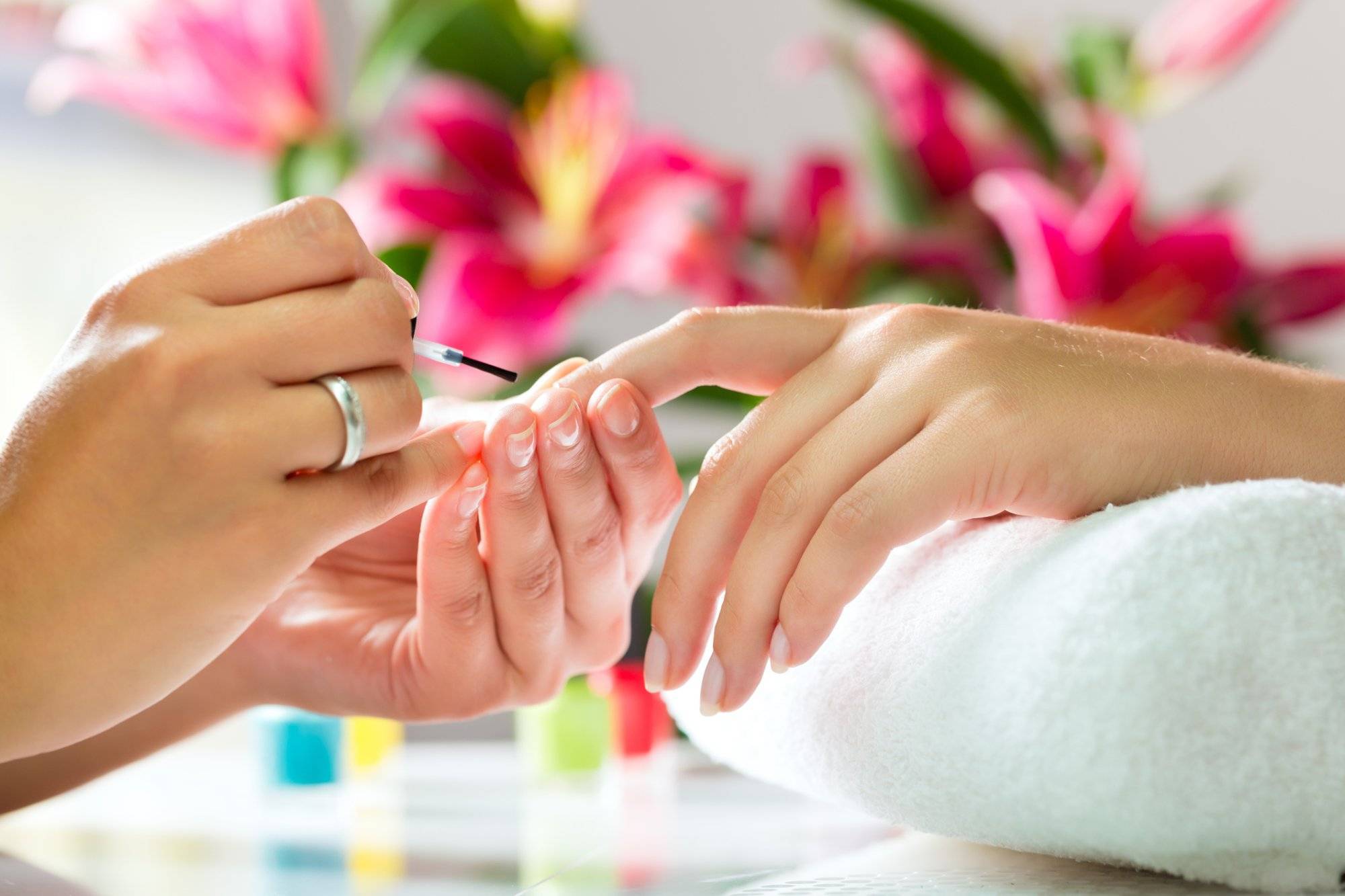 Woman in a nail salon receiving a manicure Woman in a nail salon receiving a manicure