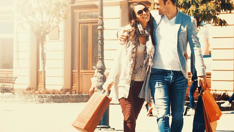 Couple shopping on sunny summer day.