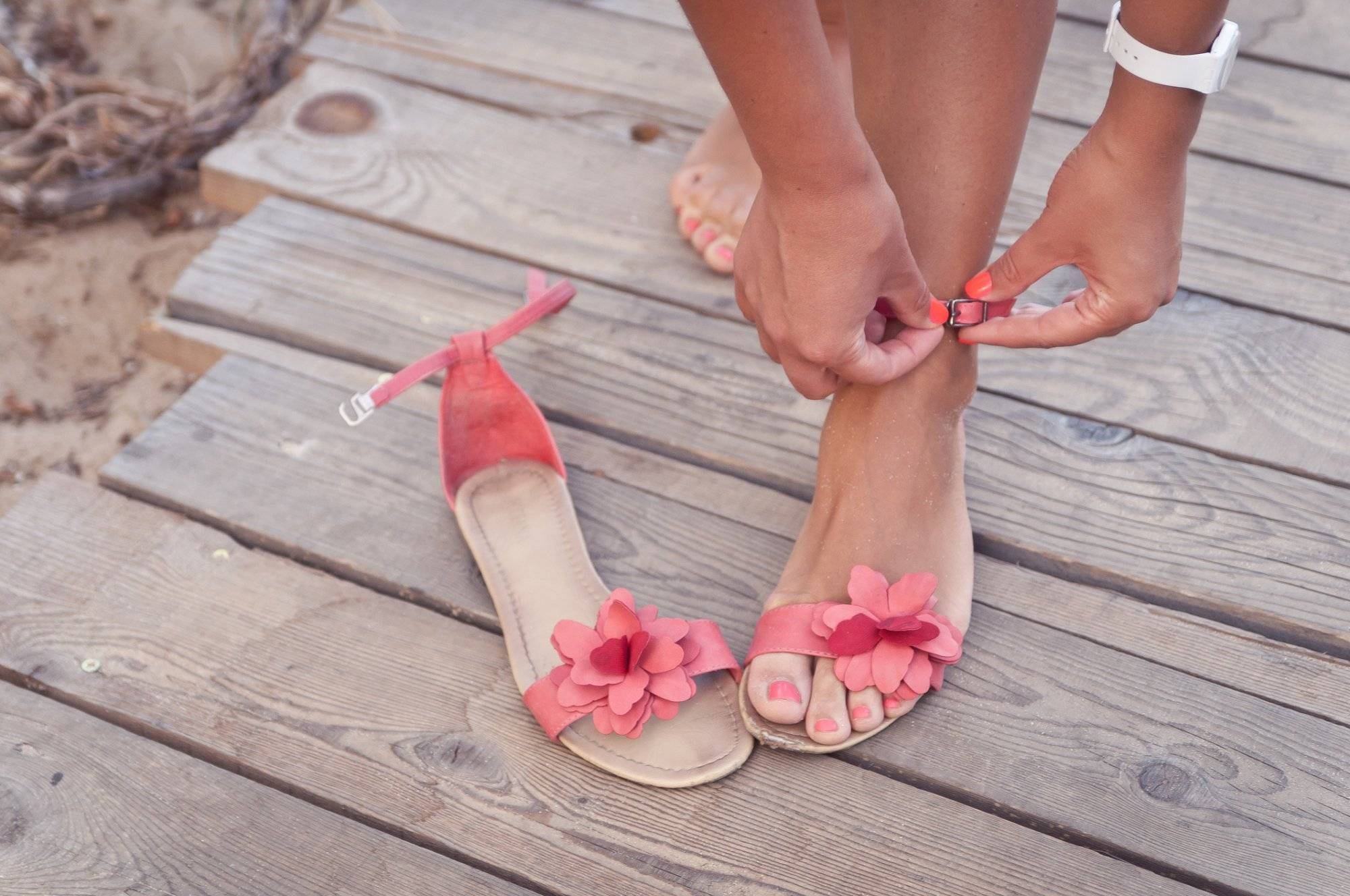 Putting on sandals at the beach